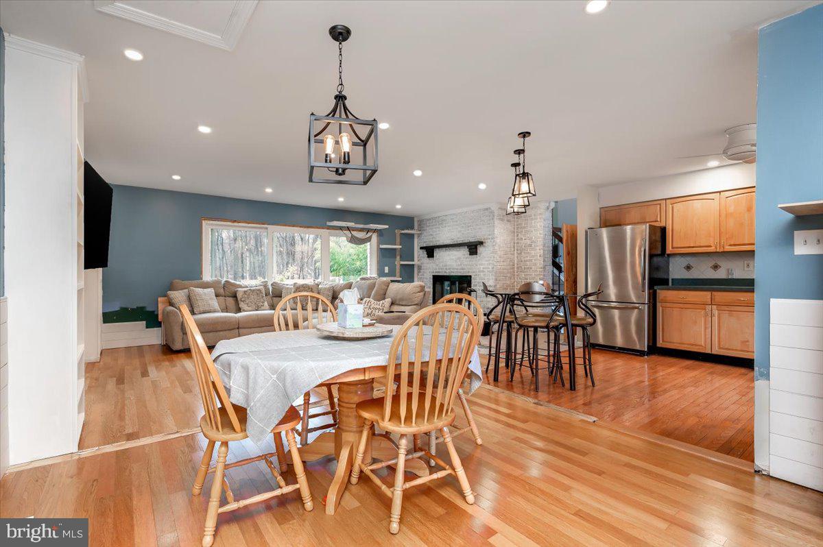 6343 Meadowland Drive Dunkirk, MD 20754 - Photo 10 of 31 a view of a dining room and livingroom with furniture wooden floor a chandelier