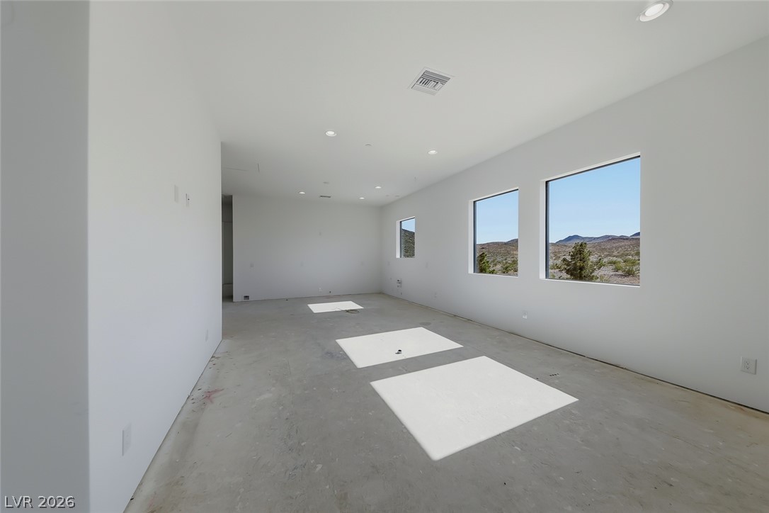 1140 Julie Road Henderson, NV 89002 - Photo 52 of 71 Clean lines and ample light fill this spacious room, framing captivating desert mountain vistas.
