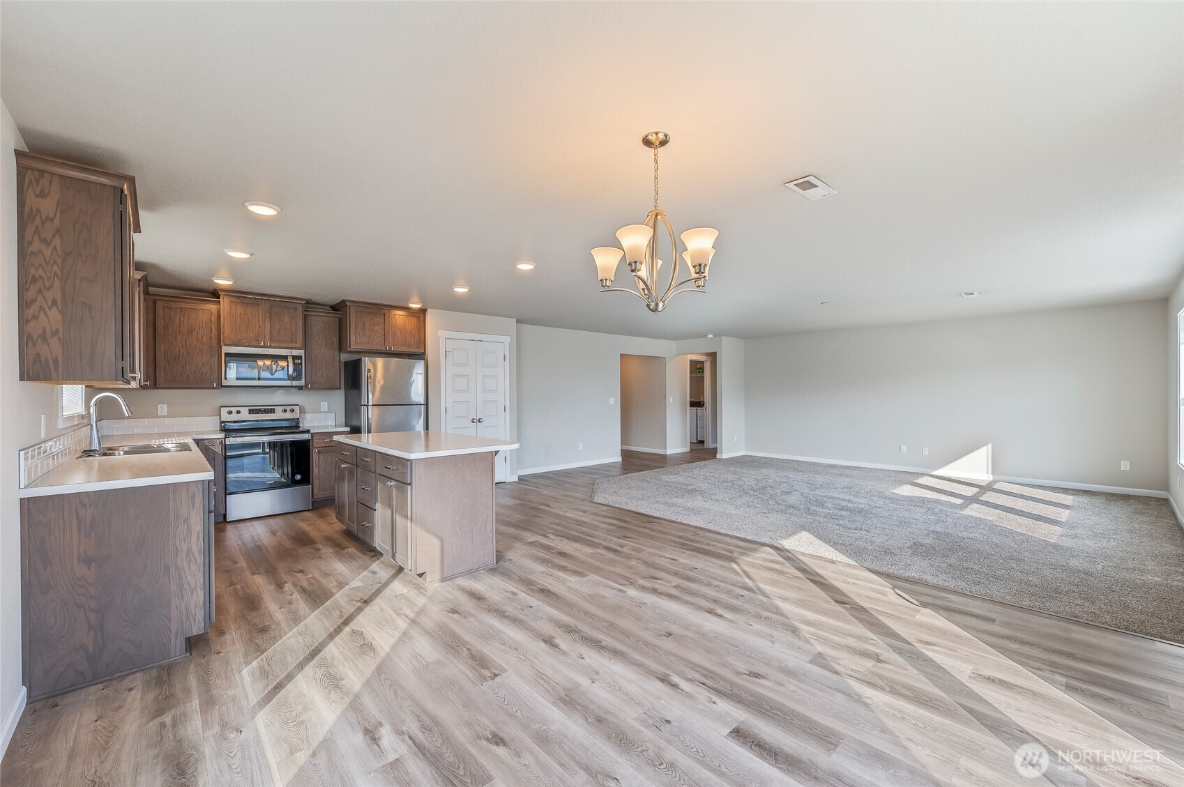 730 L Street Northeast Quincy, WA 98848 - Photo 4 of 29 a view of a kitchen with kitchen island a sink stainless steel appliances and cabinets