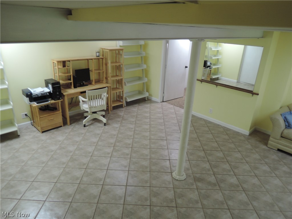 9061 Fairmount Road Novelty, OH 44072 - Photo 17 of 35 Another view of the rec room with an opening to the utility room & also a work shop area.