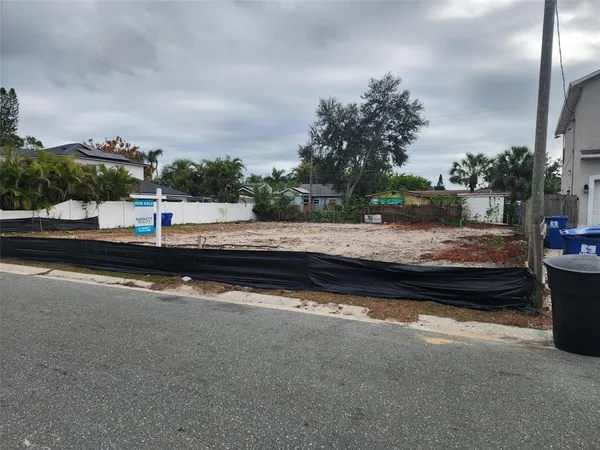 a wooden bench sitting in middle of a parking
