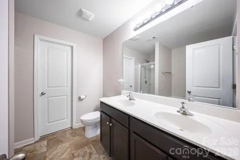 a bathroom with a tub shower and hallway