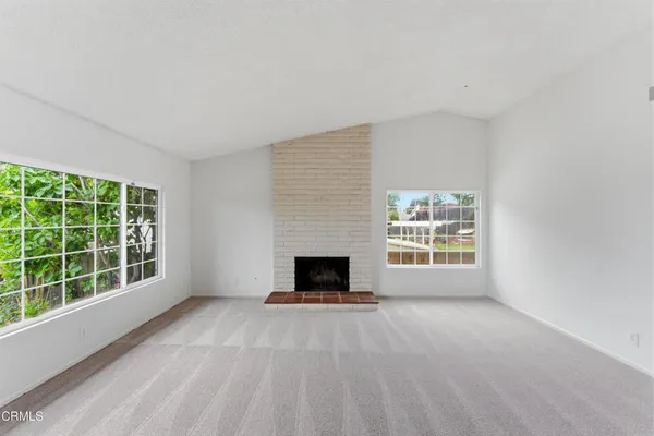 a view of empty room with a fireplace