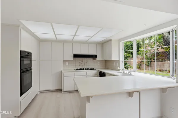 a kitchen with stainless steel appliances a refrigerator sink and stove