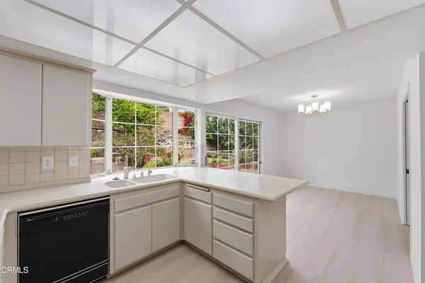 a open kitchen with a large window appliances and cabinets