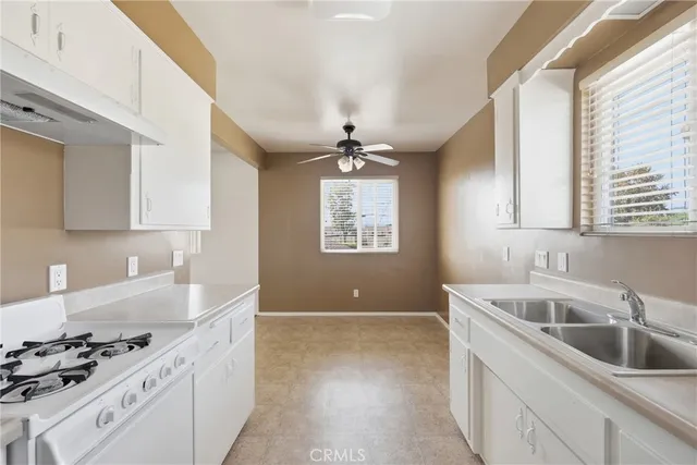 a kitchen with a sink cabinets and window