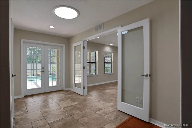 a blue bed sitting in a bedroom next to a window