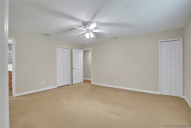 an empty room with windows and closet