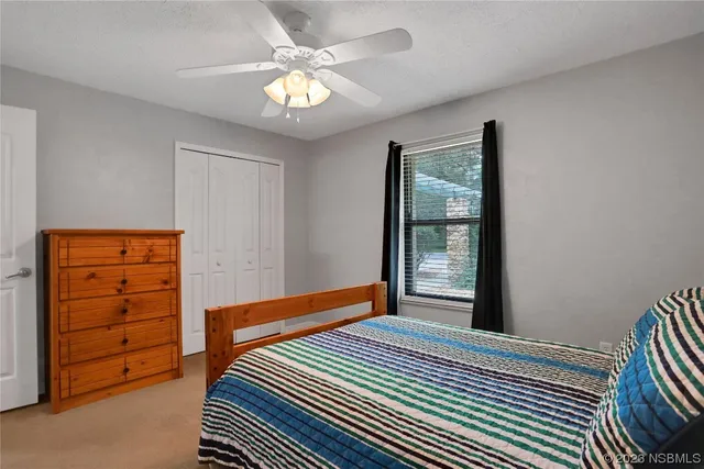 an empty room with a ceiling fan and a bathroom