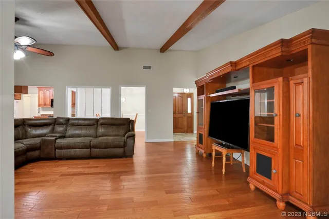 a kitchen with stainless steel appliances granite countertop a stove top oven a sink a dining table and chairs