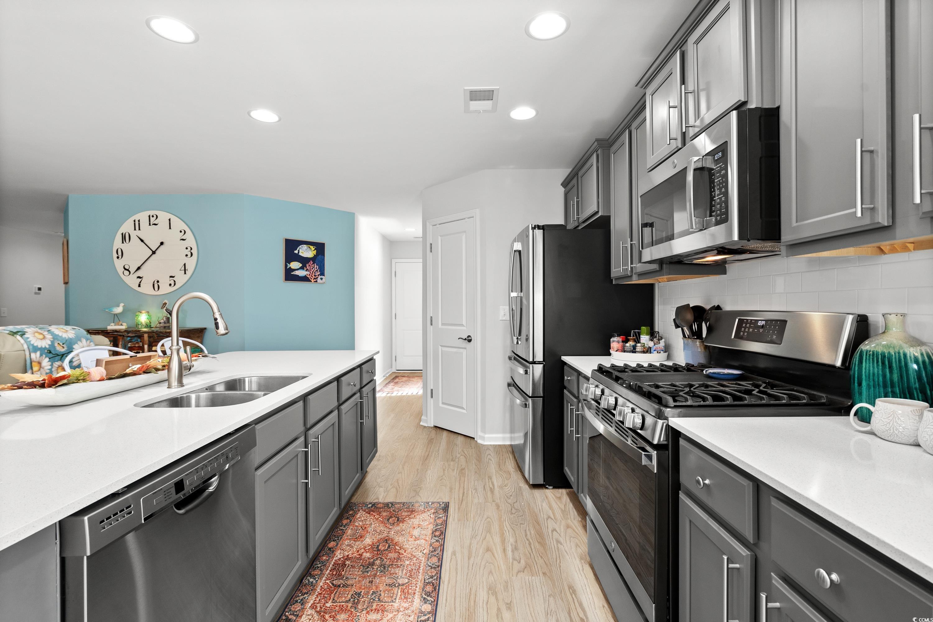 968 Cypress Way Little River, SC 29566 - Photo 14 of 40 Kitchen featuring decorative backsplash, light har