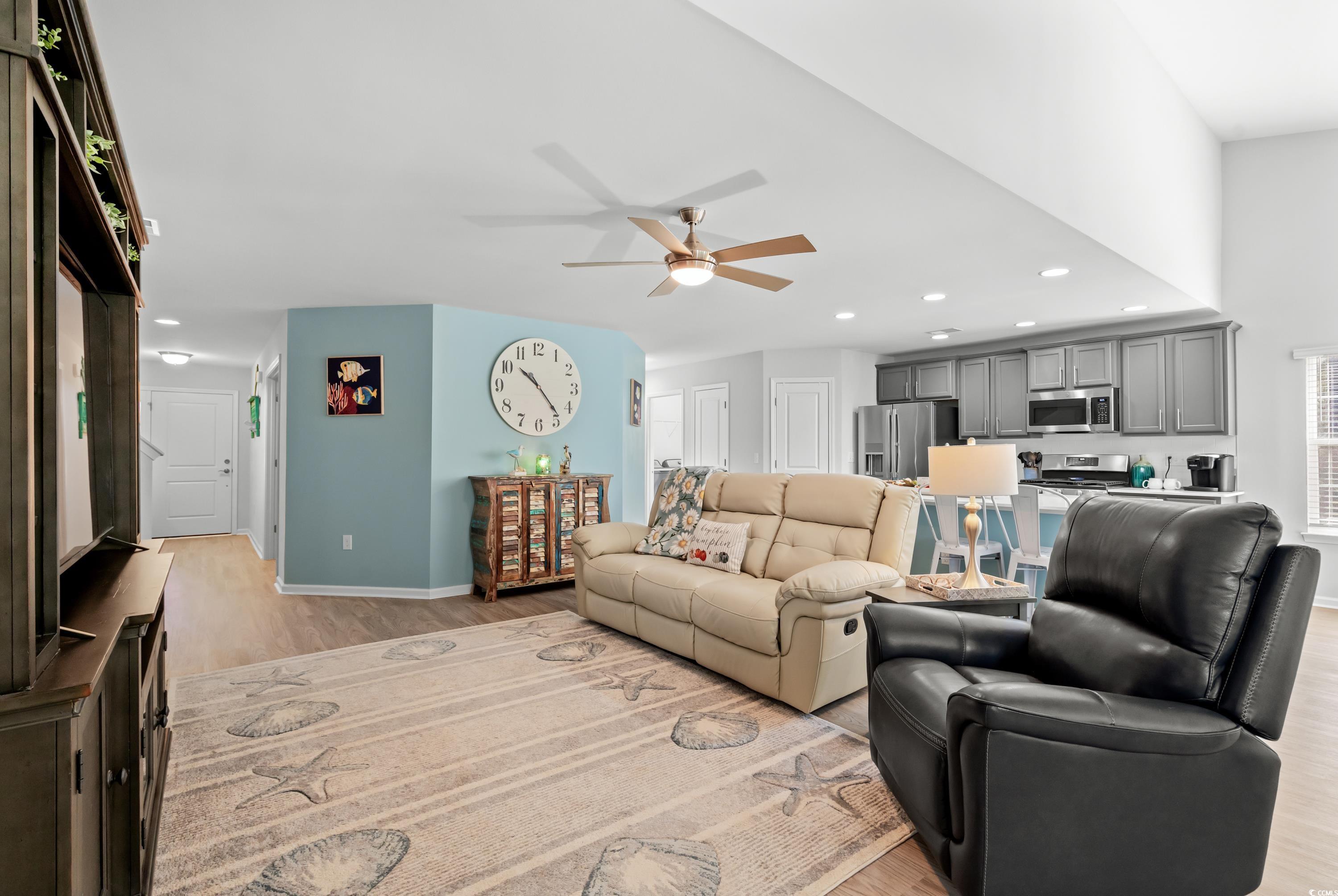 968 Cypress Way Little River, SC 29566 - Photo 8 of 40 Living room with ceiling fan and light wood-type f