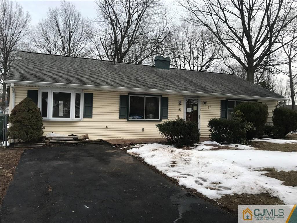 47 Kenmore Road Edison, NJ 08817 - Photo 1 of 14 a front view of a house with a yard covered in snow