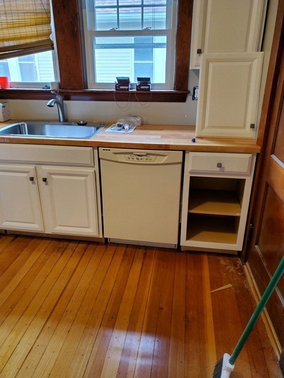 22 Allen Street, Unit 2 Arlington, MA 02474 - Photo 8 of 25 a kitchen with wooden floors and a sink