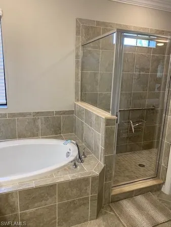 a bathroom with a shower and a bathtub