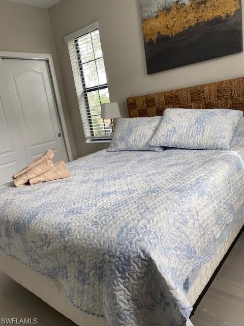1330 Oceania Drive, Unit 2 Naples, FL 34113 - Photo 23 of 30 a bedroom with a bed and a window