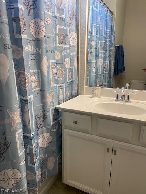 1330 Oceania Drive, Unit 2 Naples, FL 34113 - Photo 25 of 30 a bathroom with a sink and a mirror