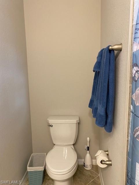 1330 Oceania Drive, Unit 2 Naples, FL 34113 - Photo 26 of 30 a white toilet sitting next to a bathroom sink