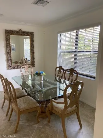 a view of a dining room with furniture and windows