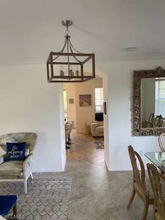 a view of a livingroom with furniture and a dining table with chairs
