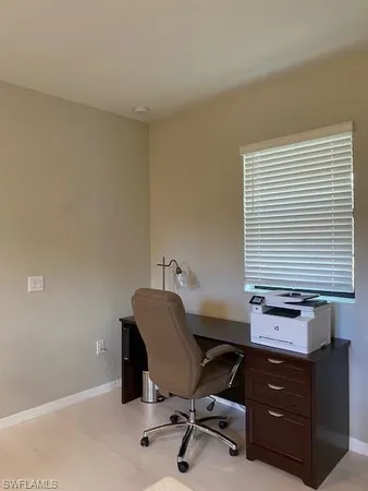 a view of a workspace with furniture