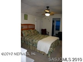 4640 Carter Road St. Augustine, FL 32086 - Photo 12 of 12 a picture of a room with a bed and a chandelier
