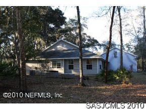 4640 Carter Road St. Augustine, FL 32086 - Photo 3 of 12 a front view of a house with a garden