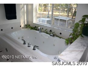 4640 Carter Road St. Augustine, FL 32086 - Photo 6 of 12 a bathroom with a tub and mirror