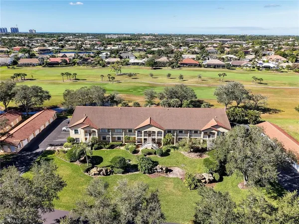 an aerial view of residential houses with outdoor space and swimming pool