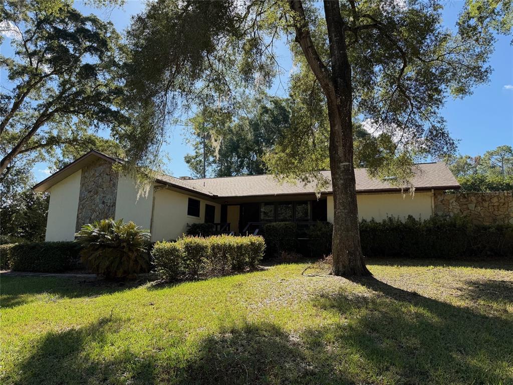 a front view of house with yard and trees