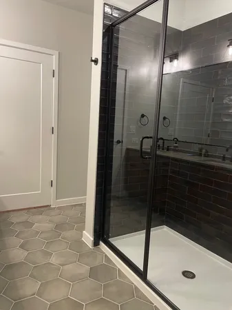 a bathroom with a glass shower door