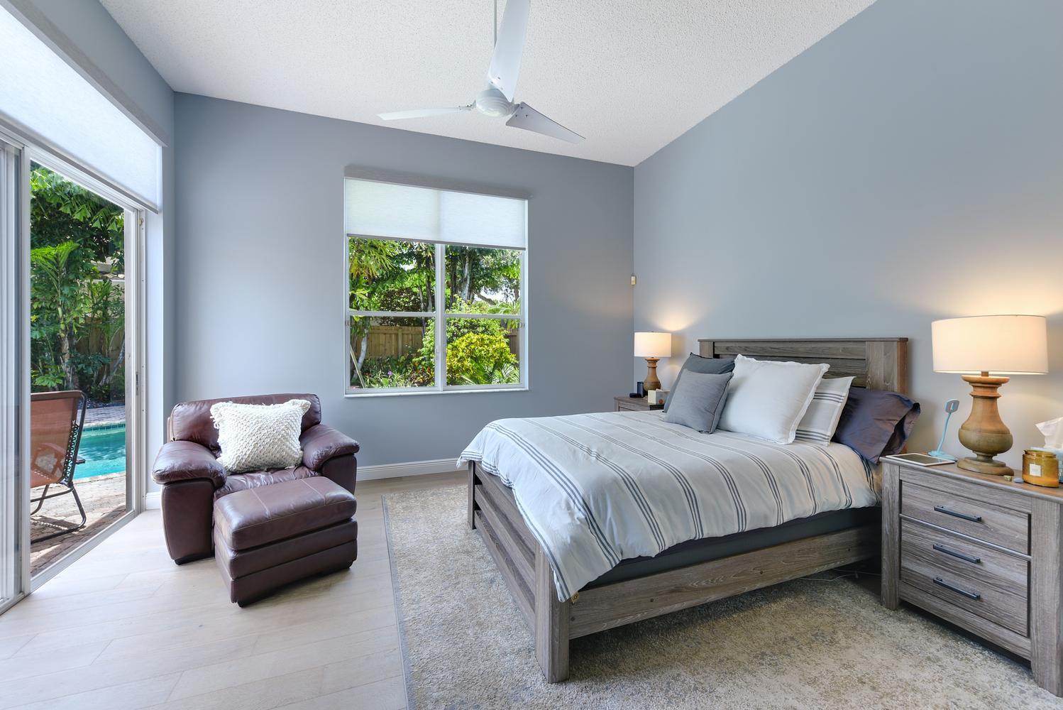 6685 Northwest 24th Terrace Boca Raton, FL 33496 - Photo 12 of 31 a bedroom with a bed and a couch next to a window
