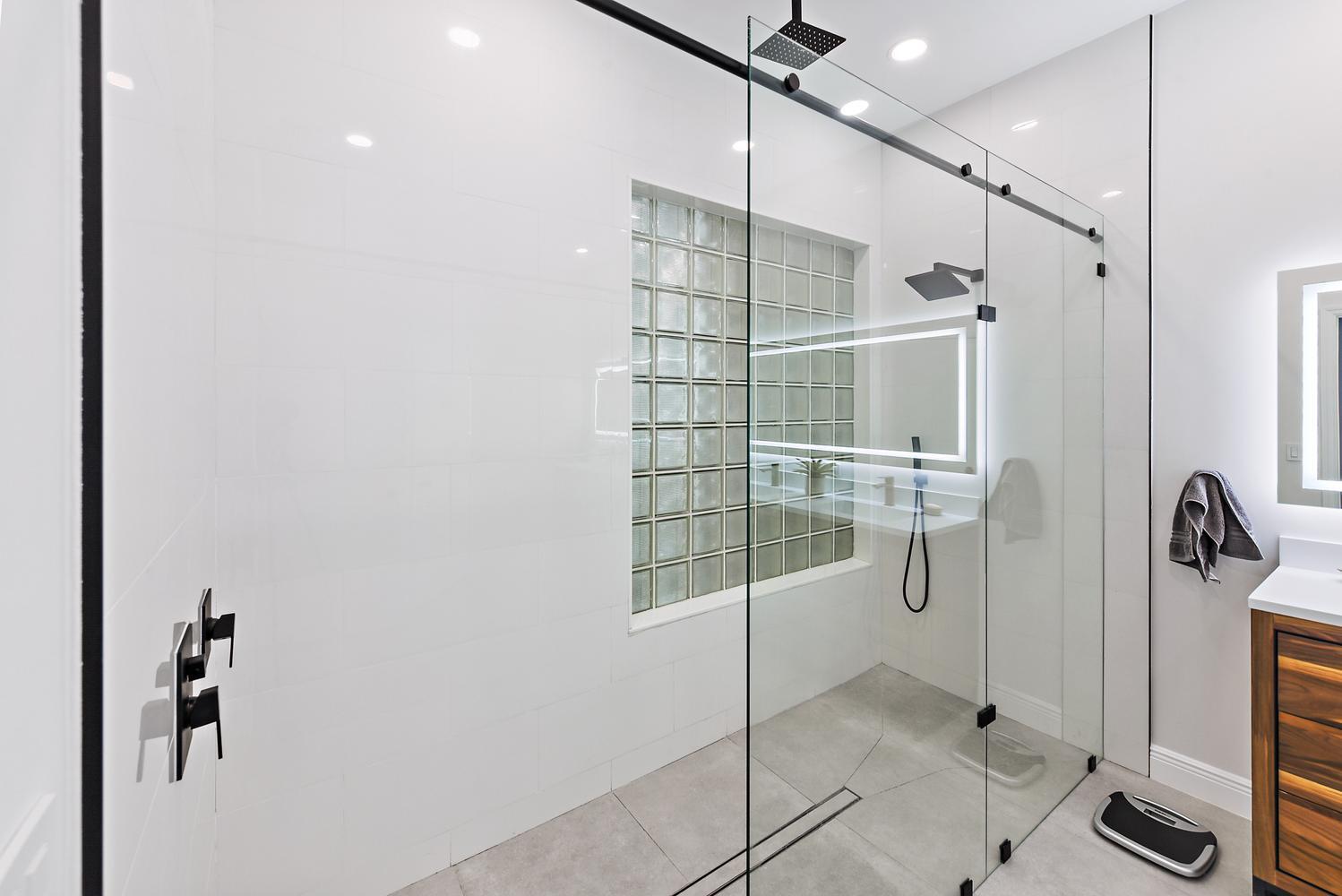 6685 Northwest 24th Terrace Boca Raton, FL 33496 - Photo 17 of 31 a bathroom with a glass shower door