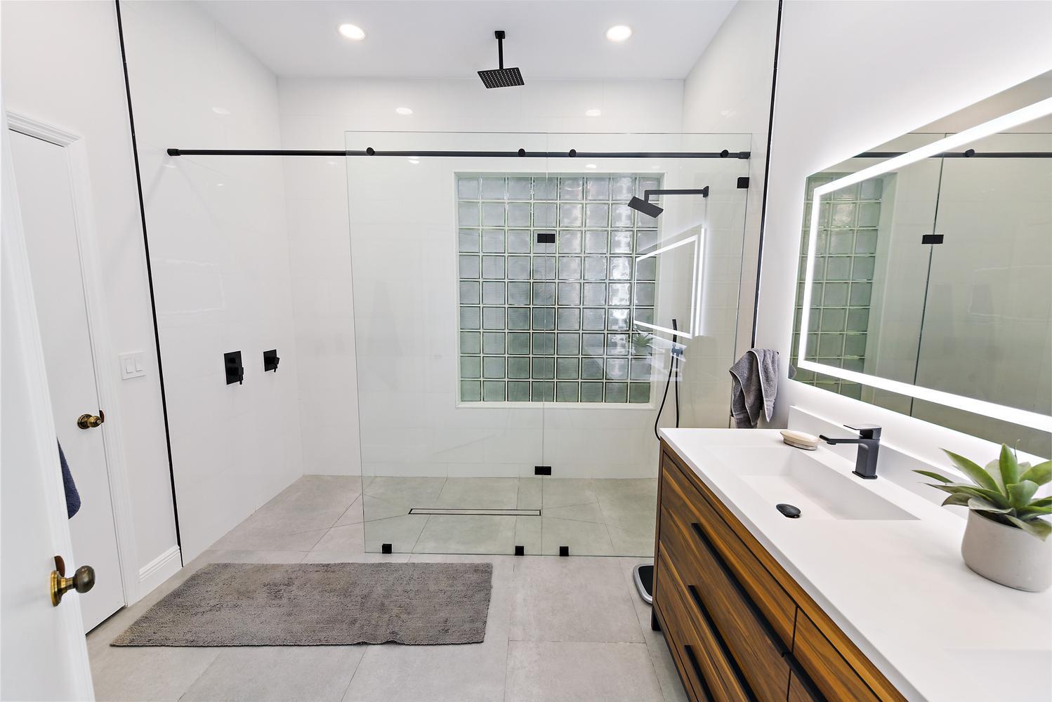 6685 Northwest 24th Terrace Boca Raton, FL 33496 - Photo 18 of 31 a bathroom with a tub sink shower and mirror