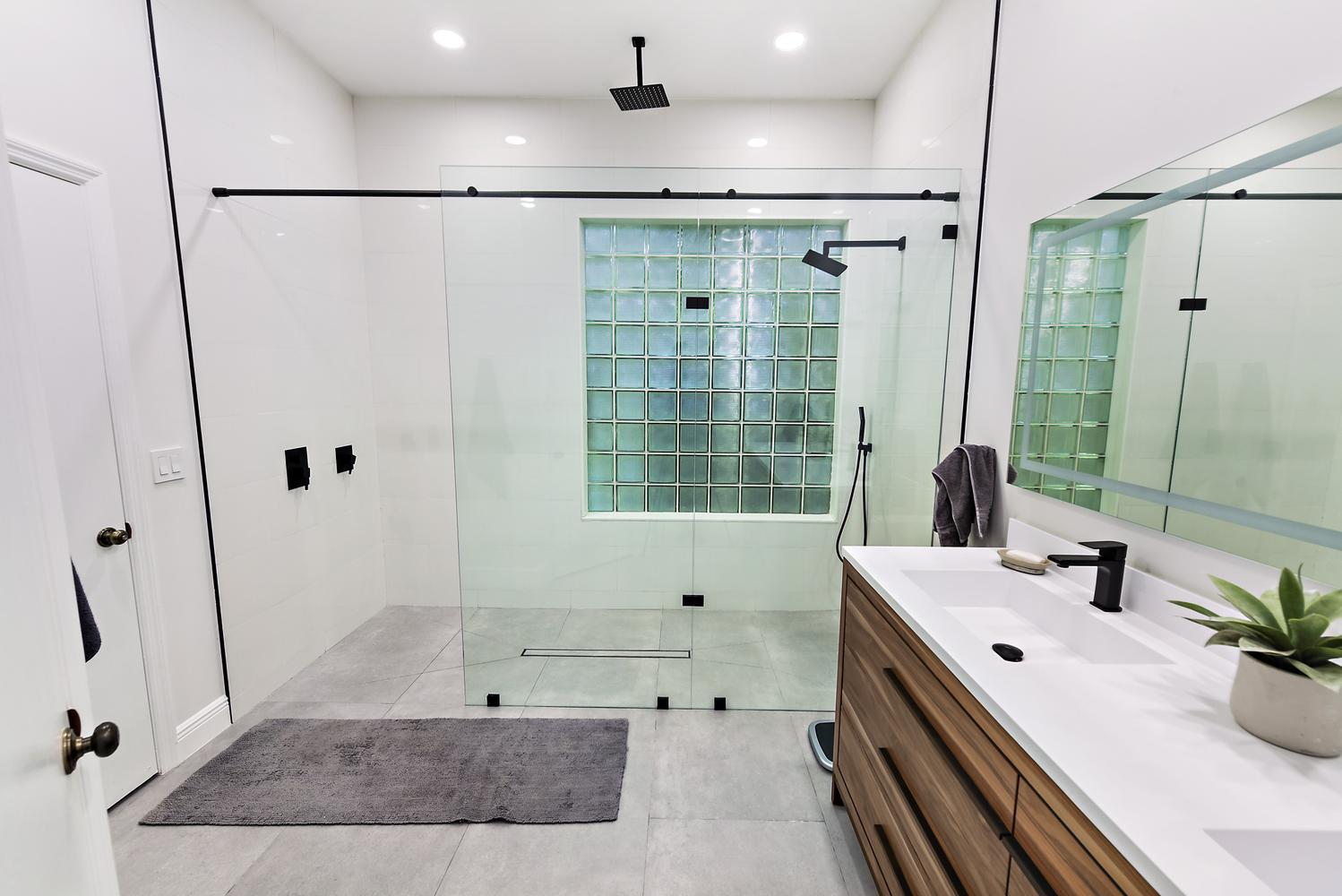 6685 Northwest 24th Terrace Boca Raton, FL 33496 - Photo 19 of 31 a bathroom with a tub a sink and mirror