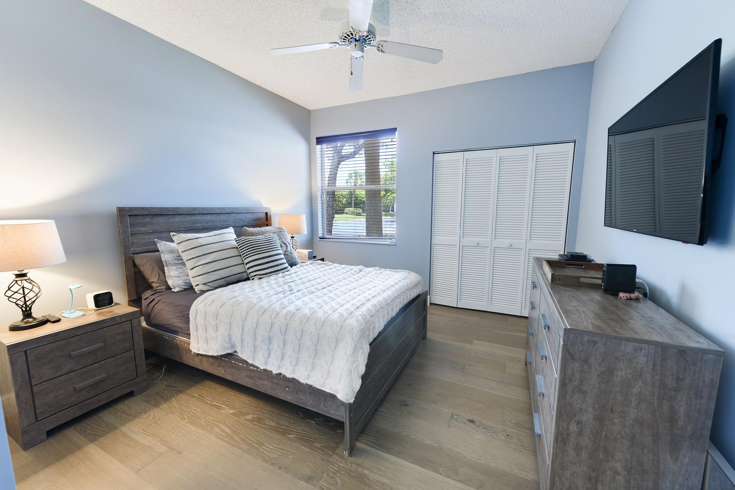 6685 Northwest 24th Terrace Boca Raton, FL 33496 - Photo 20 of 31 a bedroom with a bed and a flat screen tv