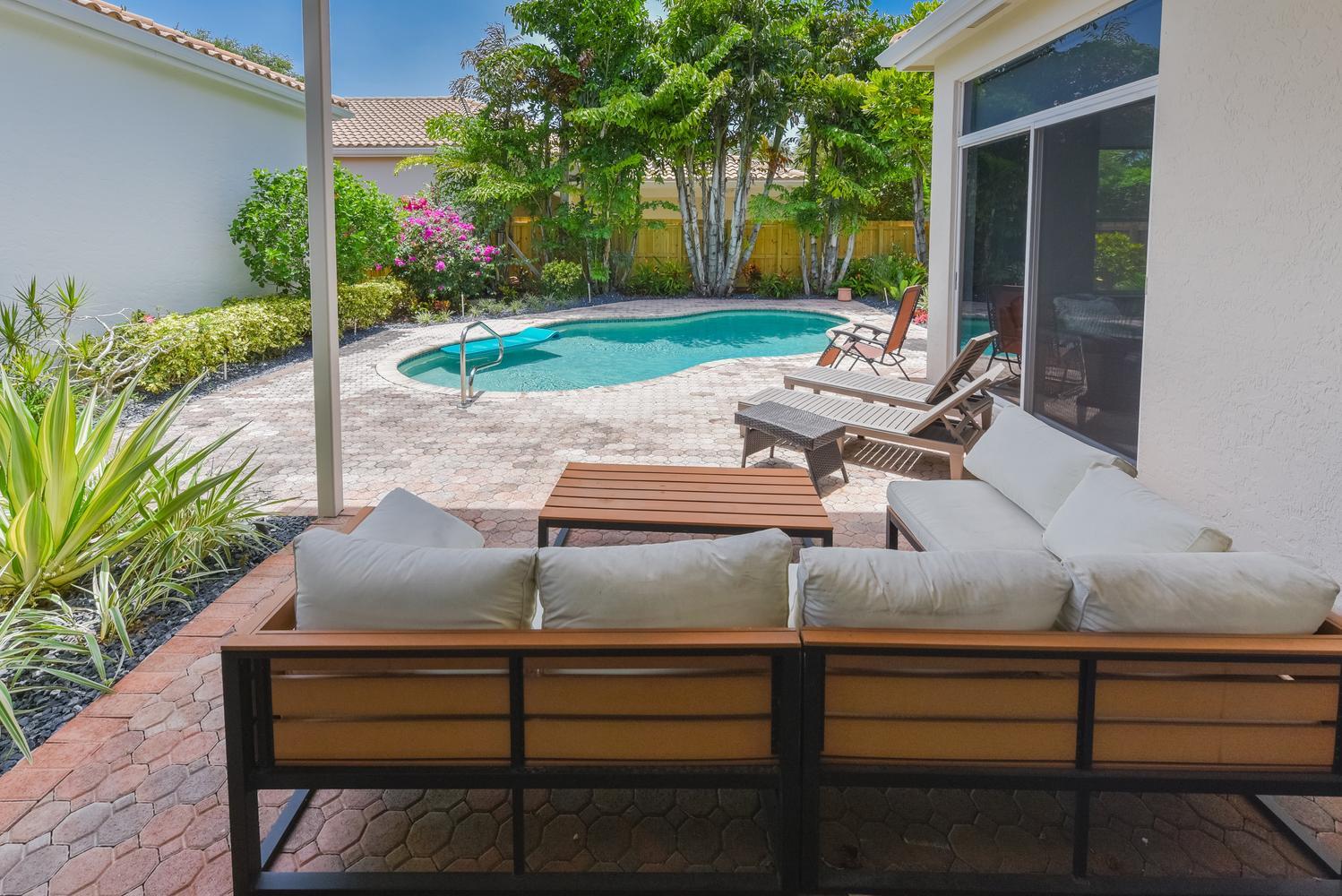 6685 Northwest 24th Terrace Boca Raton, FL 33496 - Photo 23 of 31 a view of a bench in a garden
