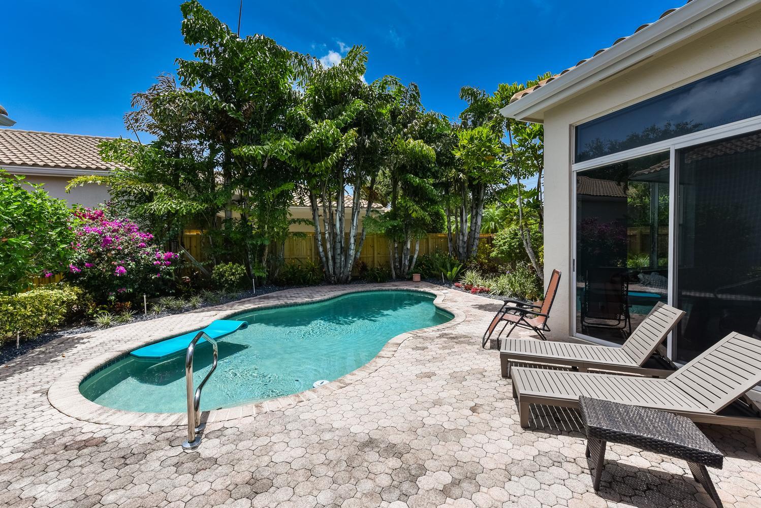 6685 Northwest 24th Terrace Boca Raton, FL 33496 - Photo 24 of 31 a house view with a seating space and garden