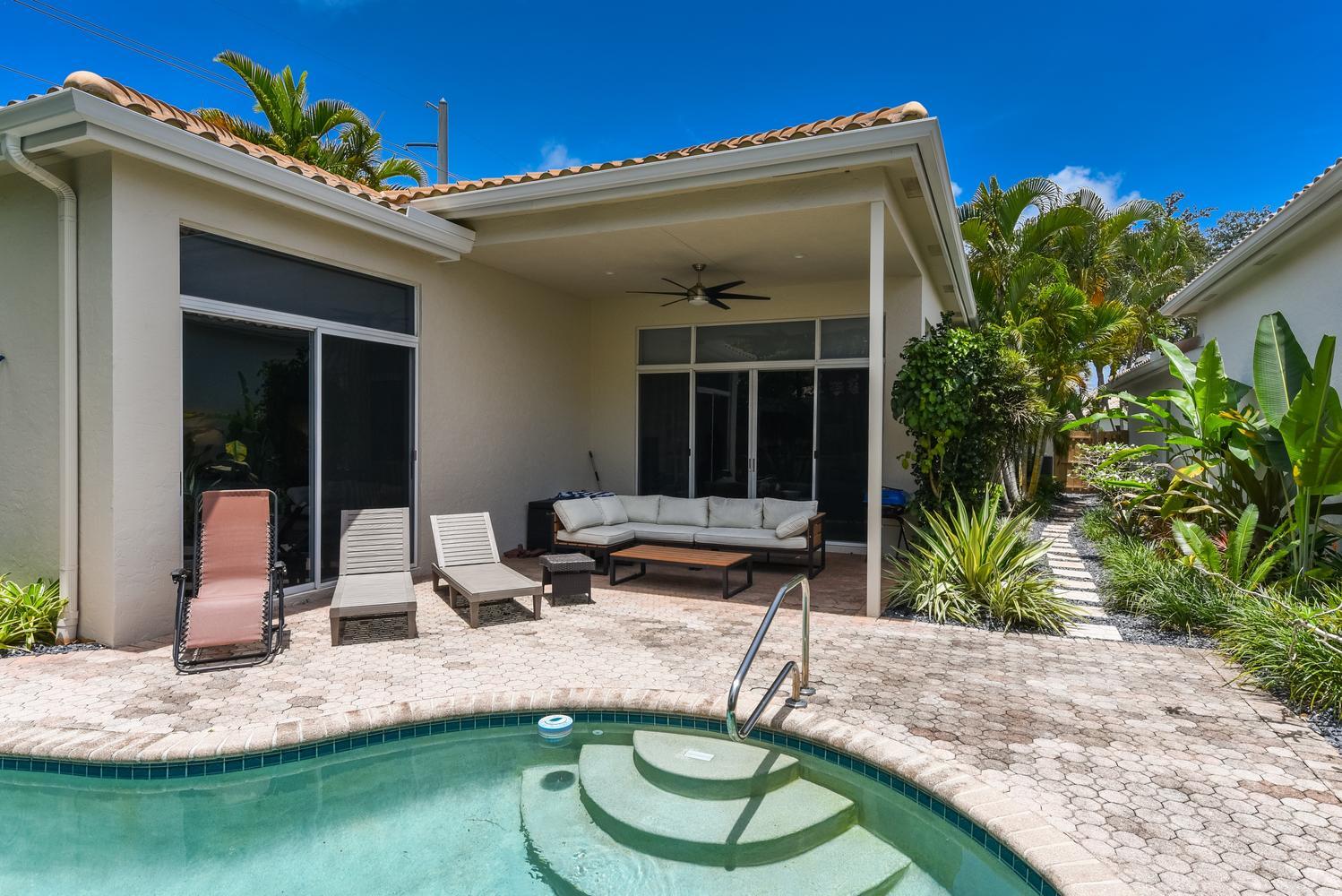 6685 Northwest 24th Terrace Boca Raton, FL 33496 - Photo 29 of 31 a view of a dinning table and chairs in patio