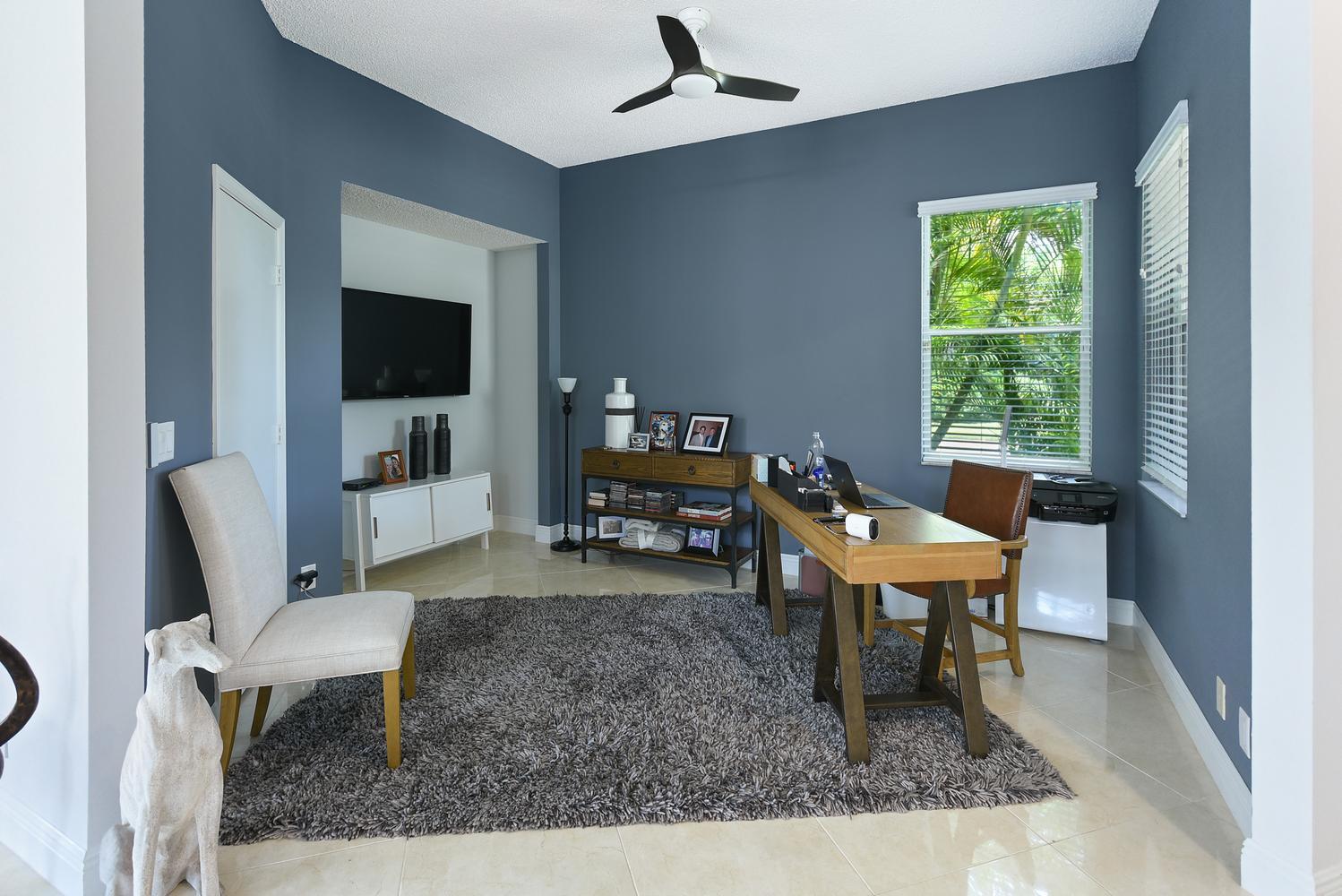 6685 Northwest 24th Terrace Boca Raton, FL 33496 - Photo 31 of 31 a living room with furniture and a flat screen tv