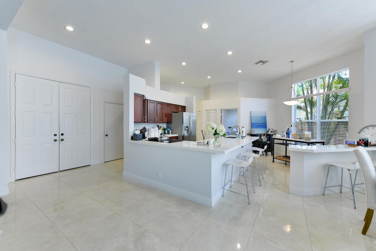6685 Northwest 24th Terrace Boca Raton, FL 33496 - Photo 4 of 31 a view of living room kitchen with stainless steel appliances granite countertop lots of counter top space