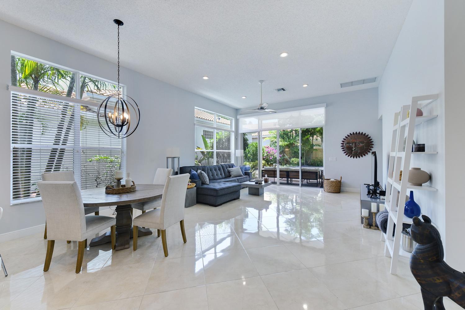 6685 Northwest 24th Terrace Boca Raton, FL 33496 - Photo 8 of 31 a living room with furniture a window and a clock