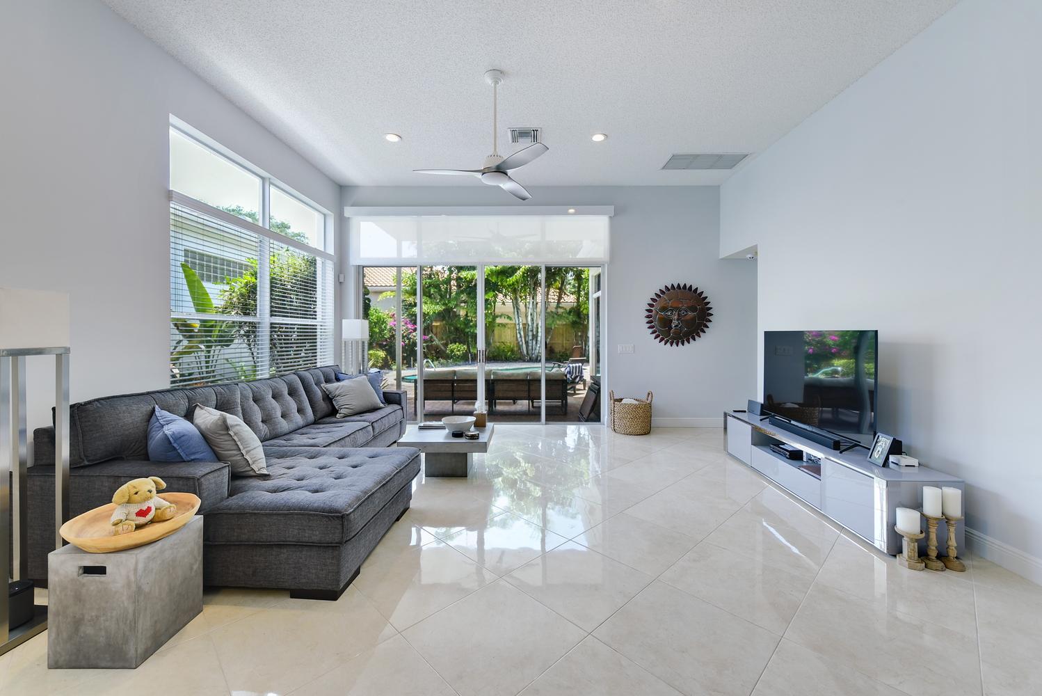 6685 Northwest 24th Terrace Boca Raton, FL 33496 - Photo 9 of 31 a living room with furniture and a flat screen tv