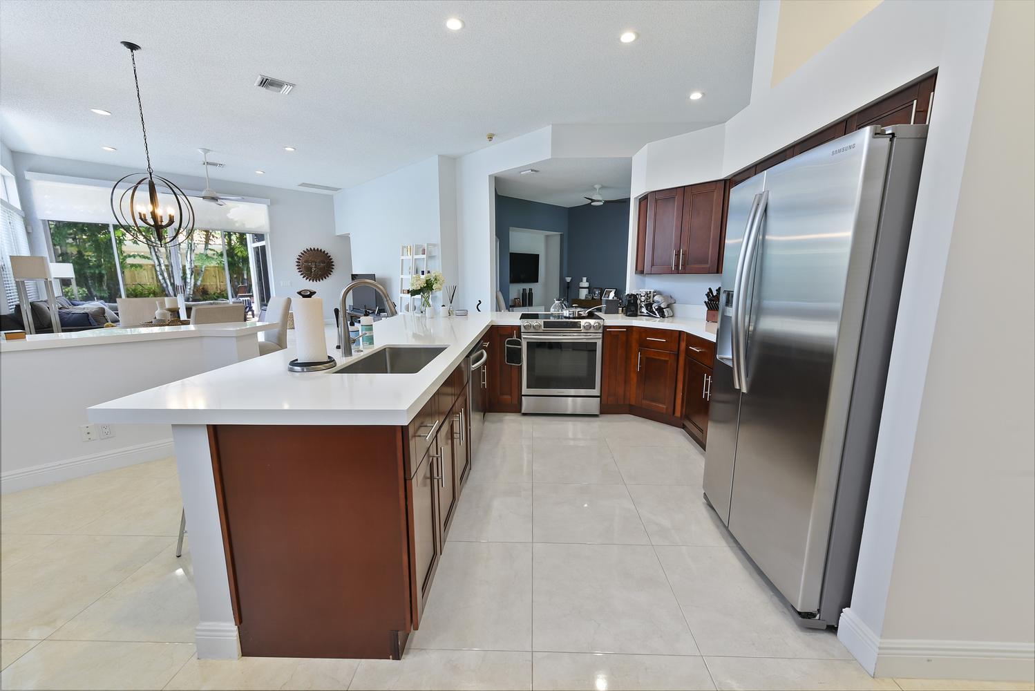 6685 Northwest 24th Terrace Boca Raton, FL 33496 - Photo 10 of 31 a kitchen with kitchen island a counter top space appliances and cabinets