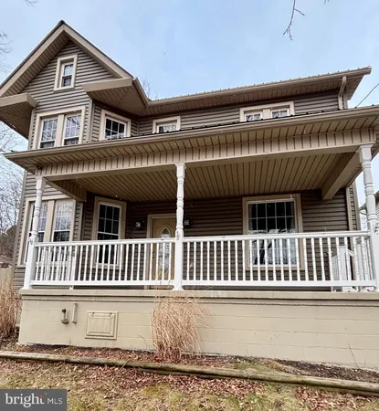 a view of a house with a wooden deck