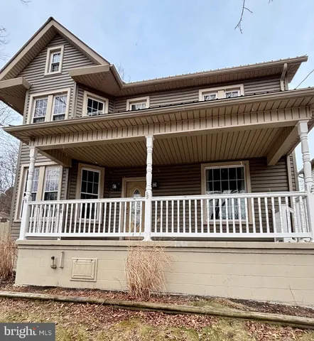 a view of a house with a wooden deck