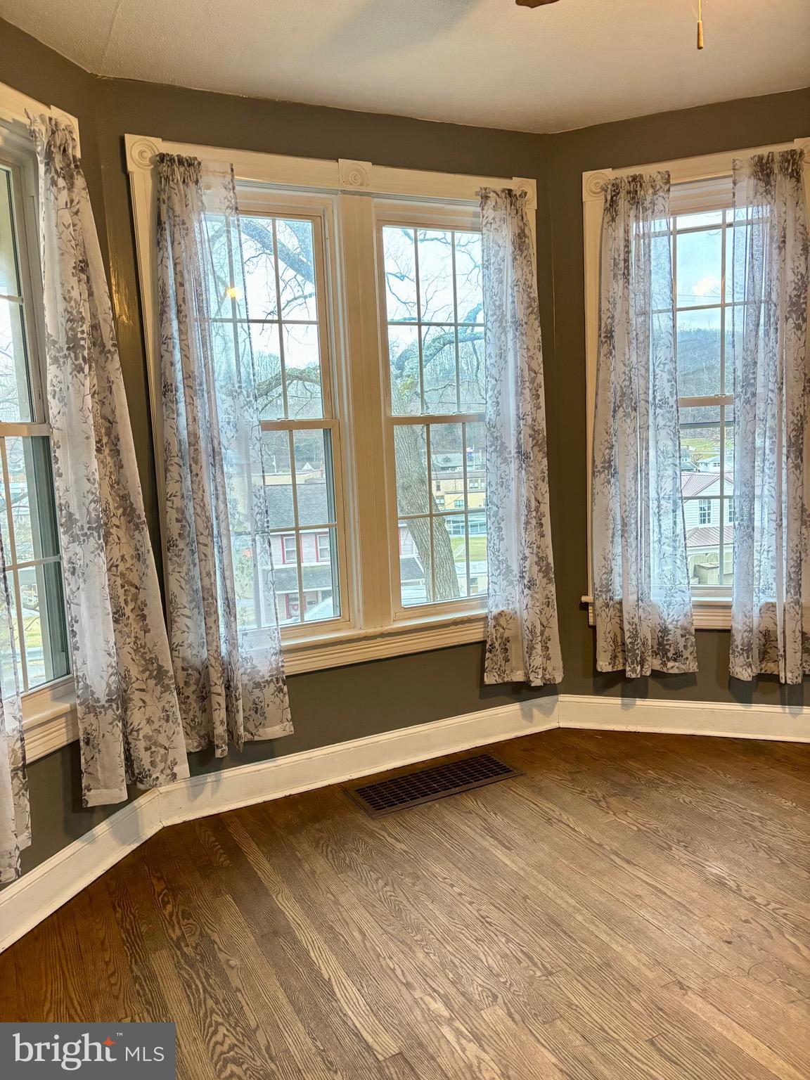 1006 Main Street Saxton, PA 16678 - Photo 16 of 40 a view of wooden floor and a window in an empty room