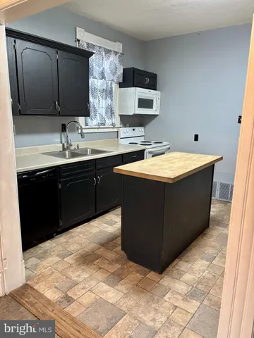 a spacious bathroom with a tub sink and mirror