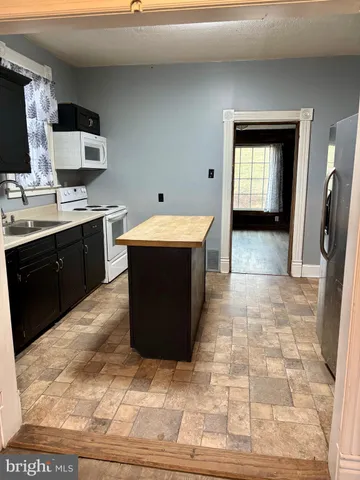 a kitchen with a sink a counter top space and appliances