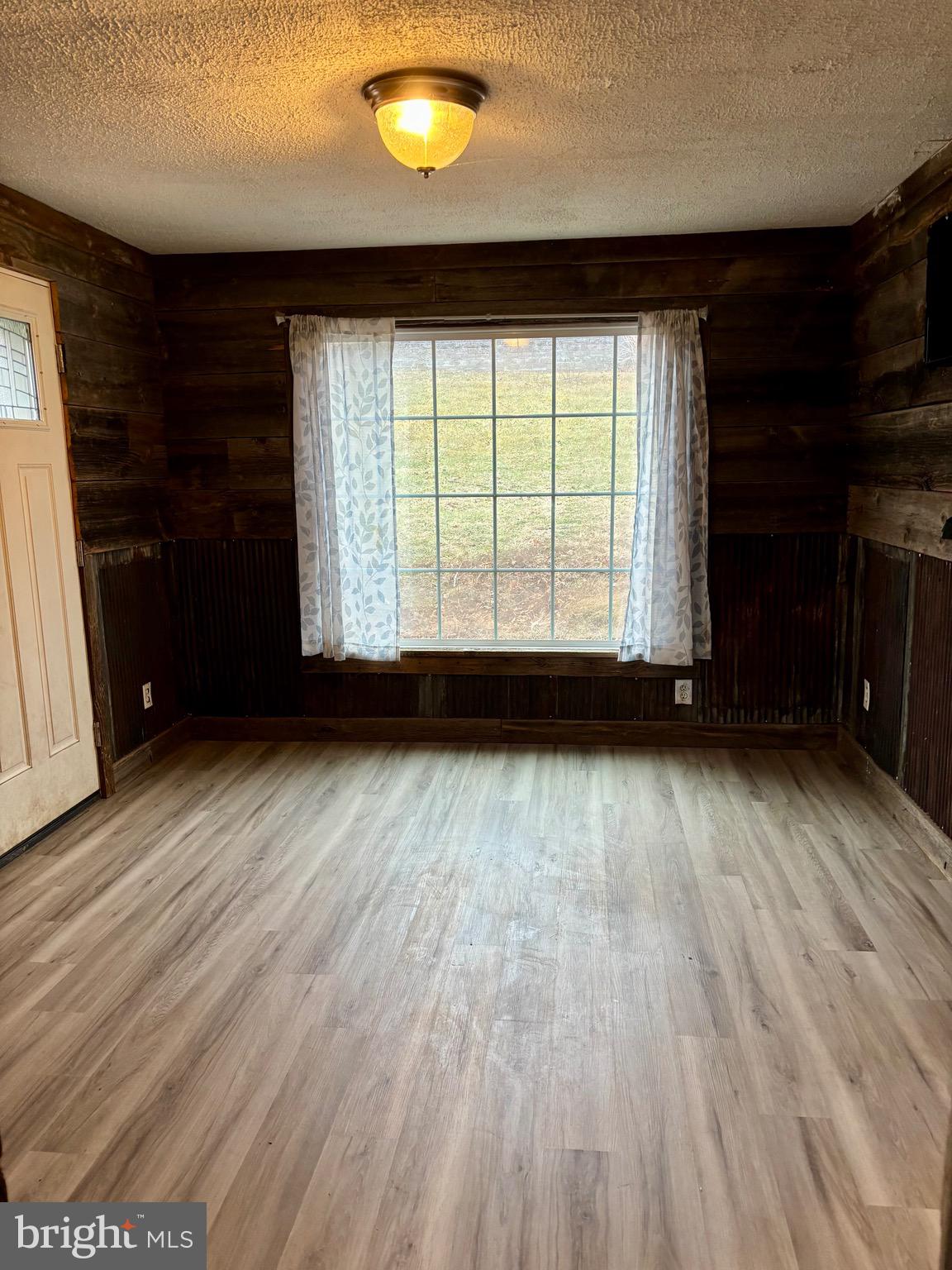 1006 Main Street Saxton, PA 16678 - Photo 22 of 40 a view of empty room with wooden floor and fan